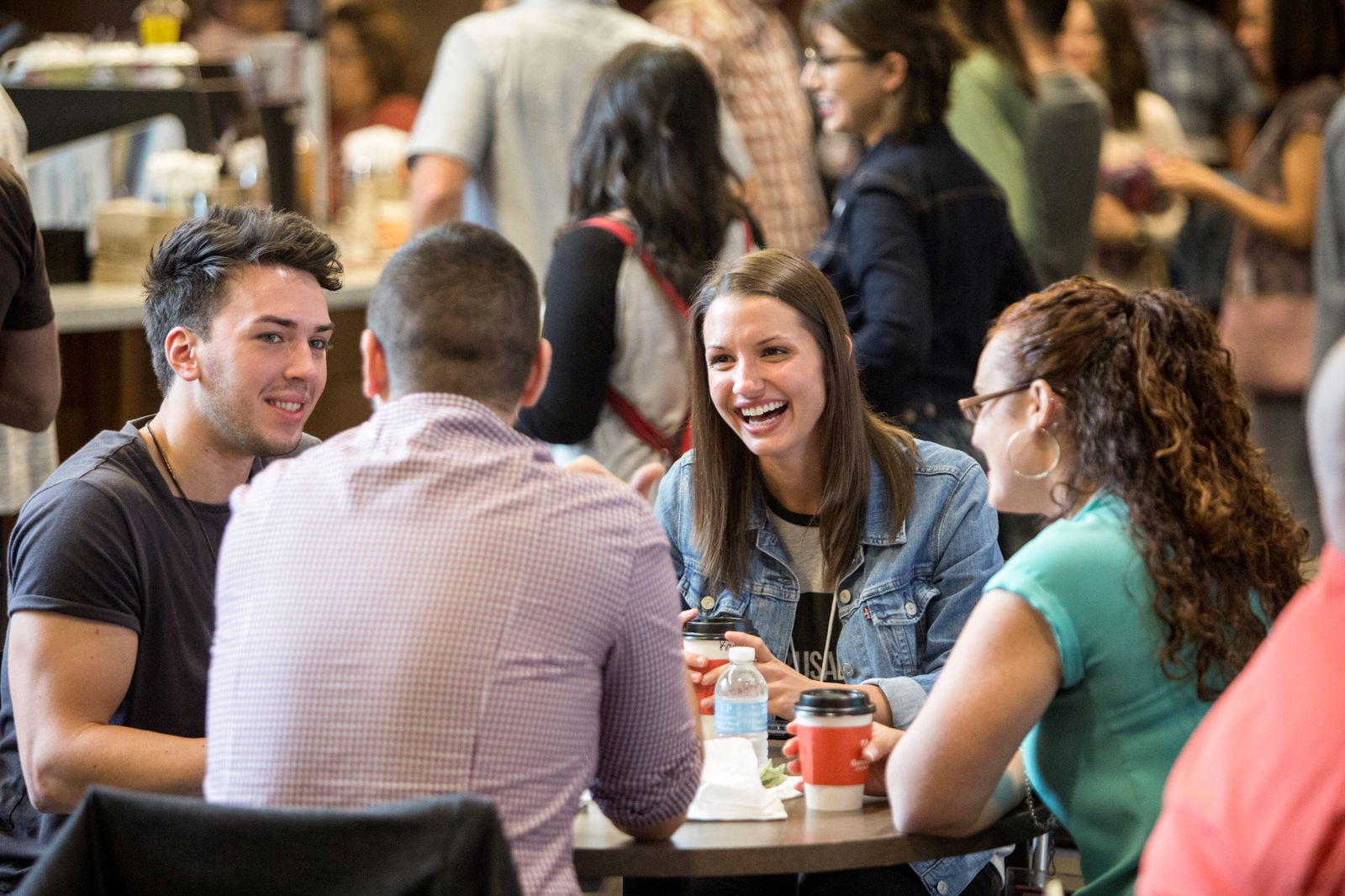Group of people sitting at a table smiling