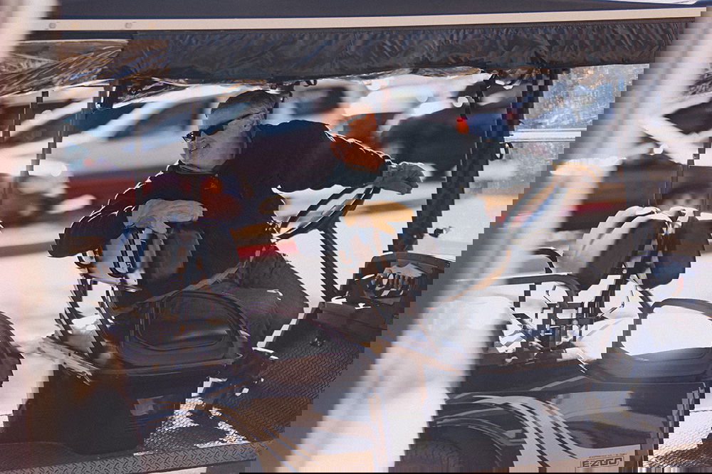 Man backing up a golf cart